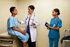 Hispanic teen with medical staff